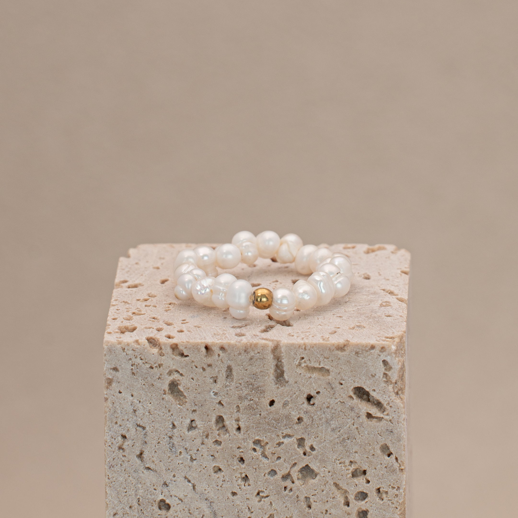 Ring aus einem Band von Süsswasserperlen und einer goldfarbenen Perle aus Edelstahl.